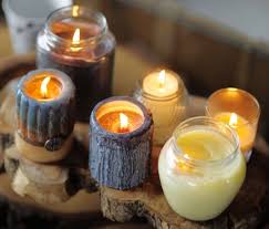 Wooden table containing a selection of lit candles
